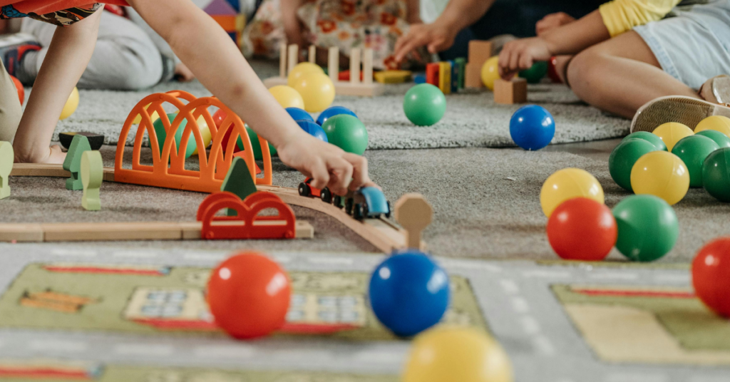 child playing with toys on a rug